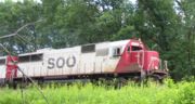 Soo Line 6022, an EMD SD 60, pulls a train through Wisconsin Dells, WI, June 20, 2004.
